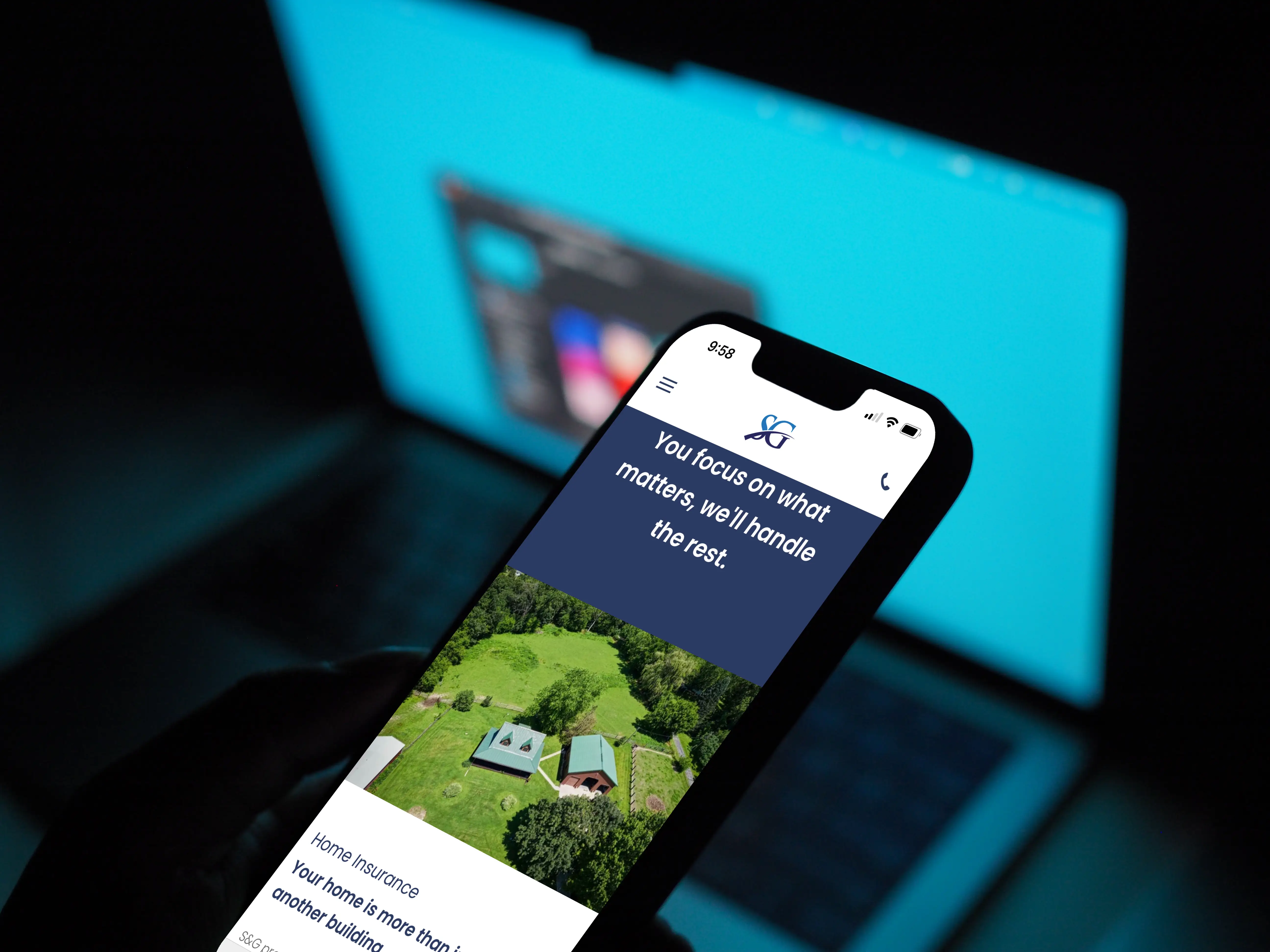 Photo of the S&G Insurance website on a smartphone. The text says 'You focus on what matters, we'll handle the rest